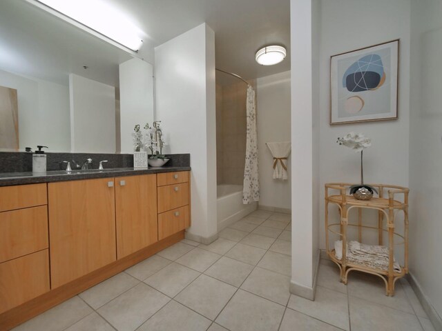 bathroom with tile patterned flooring, shower / bath combo, and vanity