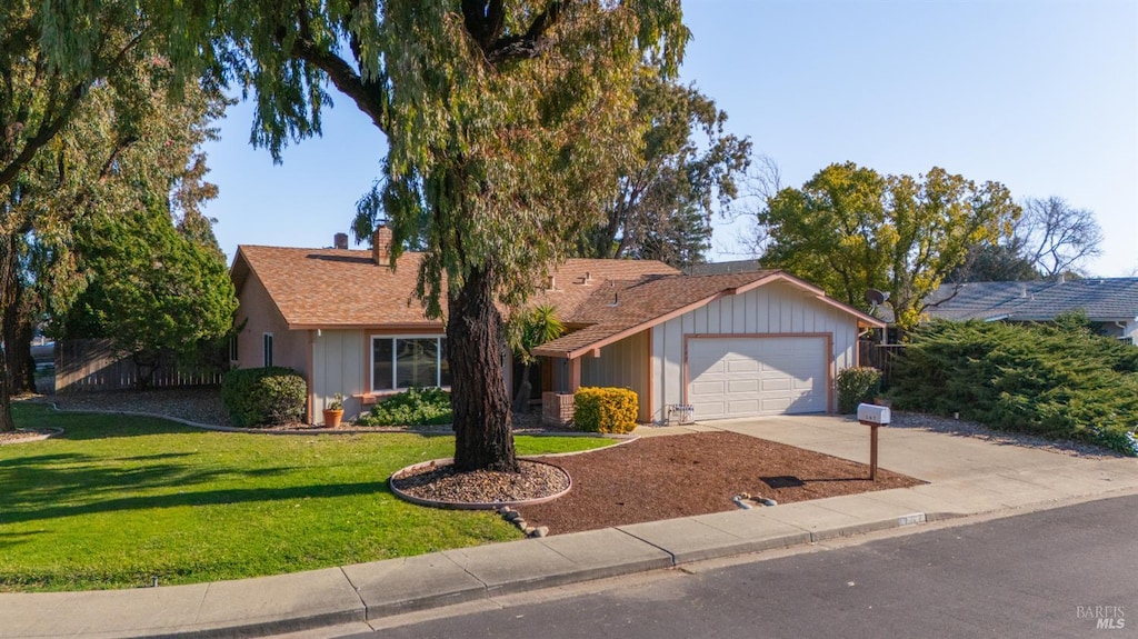 single story home with a front yard and a garage