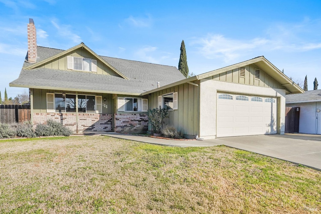 view of front of house with a garage and a front yard