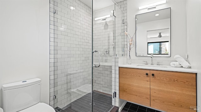 full bath featuring vanity, tile patterned flooring, toilet, and a shower stall