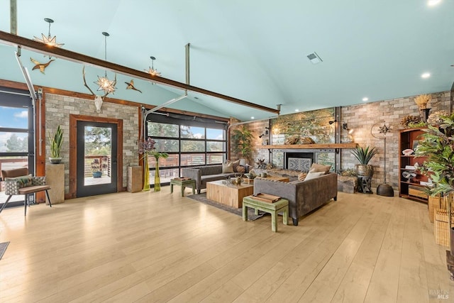 living area with a wealth of natural light, hardwood / wood-style floors, a fireplace, and visible vents