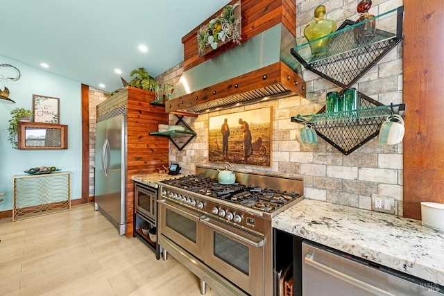 2135 E 2nd St, Benicia, CA 94510 - kitchen featuring open shelves, wall chimney exhaust hood, built in appliances, light stone countertops, and decorative backsplash