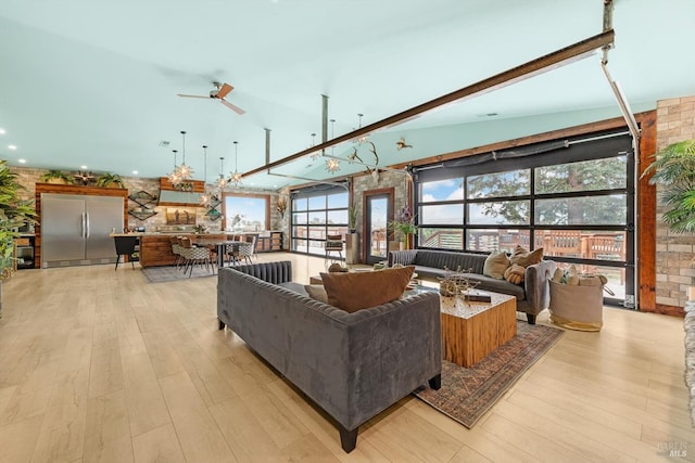 living room with ceiling fan and light wood-style flooring