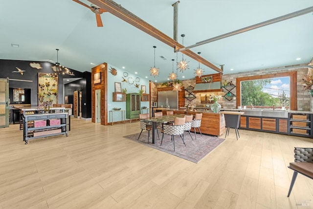 dining room with light wood finished floors, visible vents, high vaulted ceiling, and a notable chandelier