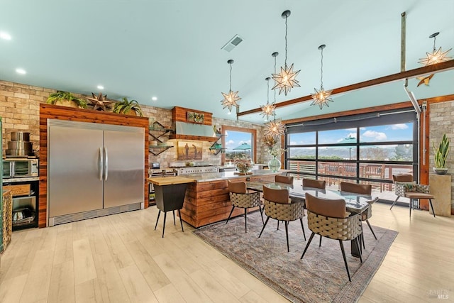 dining area featuring a chandelier, a wealth of natural light, visible vents, and light wood finished floors