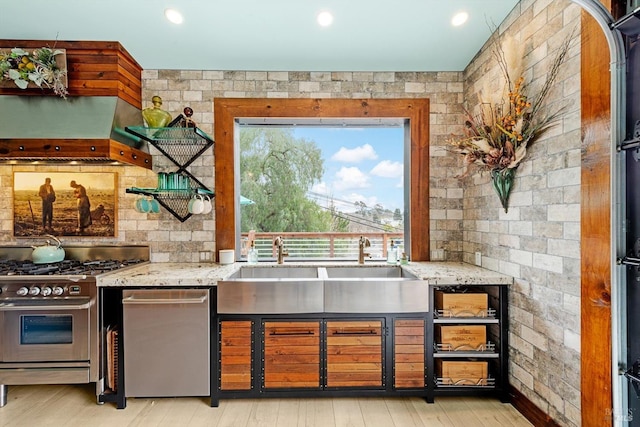 bar featuring light wood finished floors, custom range hood, stainless steel appliances, a sink, and recessed lighting