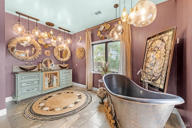 interior space featuring a freestanding bath, vanity, and baseboards