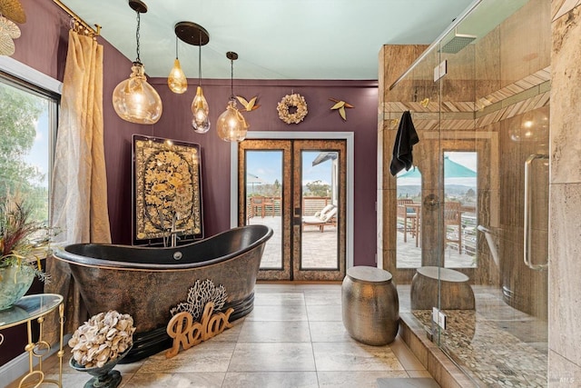 full bath with a stall shower, a freestanding tub, and french doors