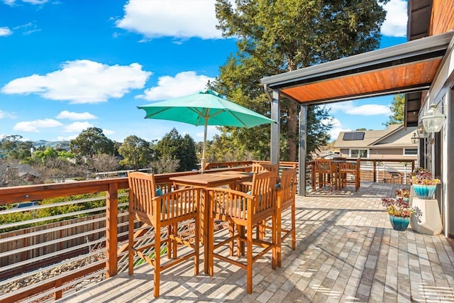 wooden terrace featuring outdoor dining area