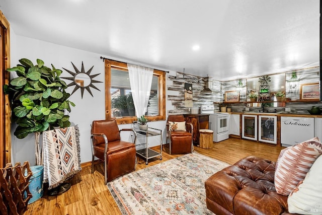 living area featuring wine cooler and wood finished floors