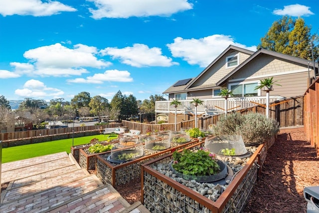 exterior space featuring a garden, a fenced backyard, and a yard