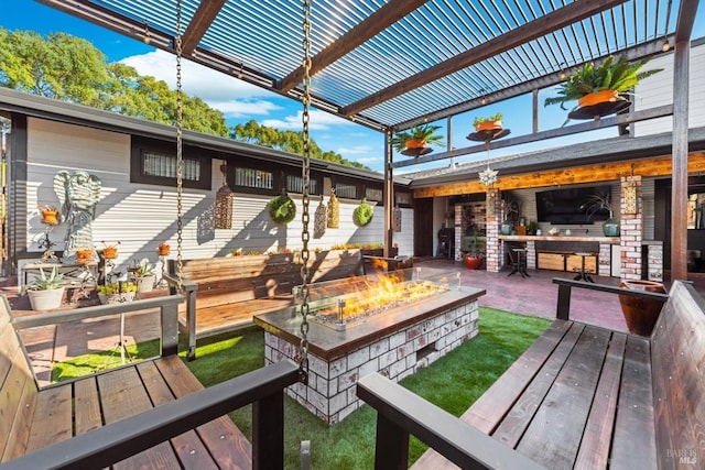 exterior space featuring an outdoor fire pit, a lawn, and a pergola