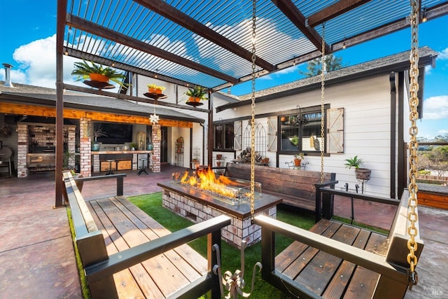 view of patio / terrace with a fire pit and a pergola