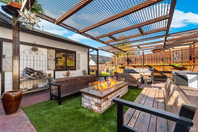 wooden deck featuring a hot tub, fence, a fire pit, and a pergola