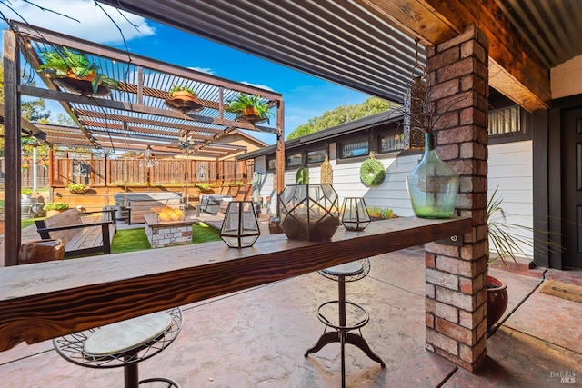 view of patio featuring fence, a fire pit, outdoor dry bar, and a pergola