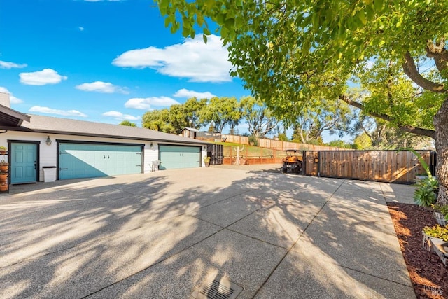 exterior space with a garage and fence