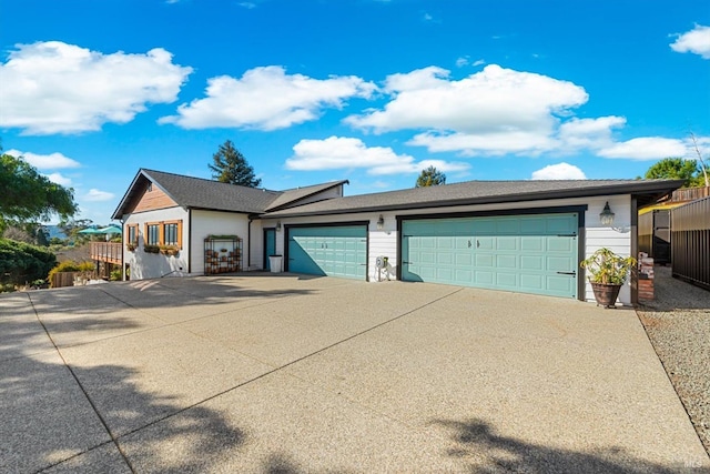 view of front of home with concrete driveway and an attached garage