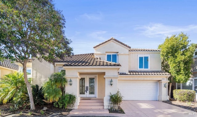 mediterranean / spanish home featuring concrete driveway, a tile roof, an attached garage, and stucco siding