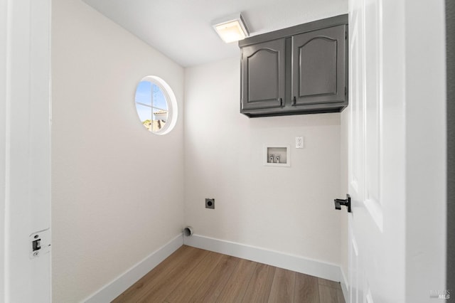 laundry room with hookup for a washing machine, light wood-style flooring, cabinet space, and hookup for an electric dryer