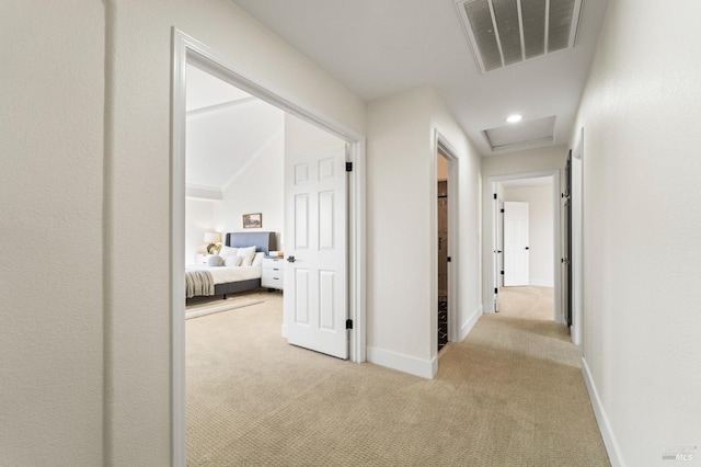 hallway with light carpet, attic access, visible vents, baseboards, and recessed lighting