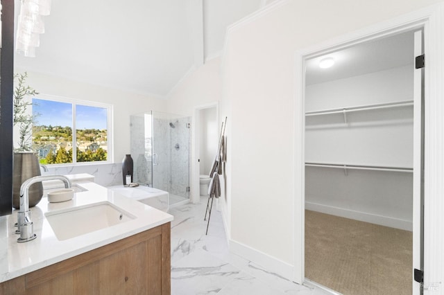 full bath featuring lofted ceiling, baseboards, marble finish floor, a stall shower, and a walk in closet