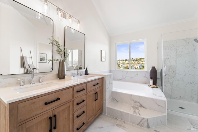 full bath with vaulted ceiling, marble finish floor, a sink, and a bath