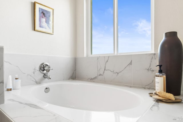 full bathroom with a wealth of natural light and a bath