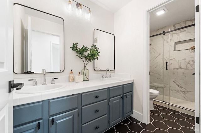 full bath with toilet, double vanity, a marble finish shower, and a sink