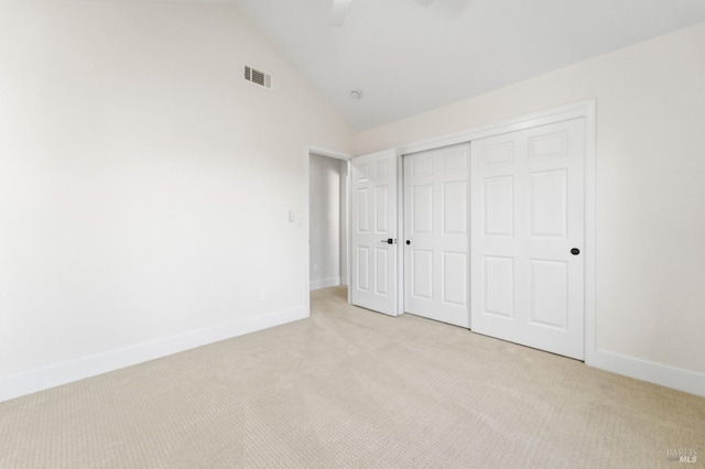 unfurnished bedroom with ceiling fan, light colored carpet, visible vents, baseboards, and a closet