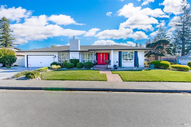 ranch-style house featuring a garage and a front yard