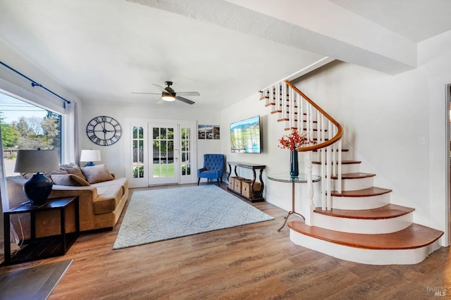 living room featuring ceiling fan and hardwood / wood-style floors