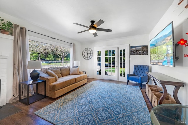 living room featuring ceiling fan and dark wood-type flooring