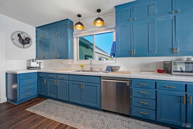 kitchen with sink, dishwasher, and blue cabinetry