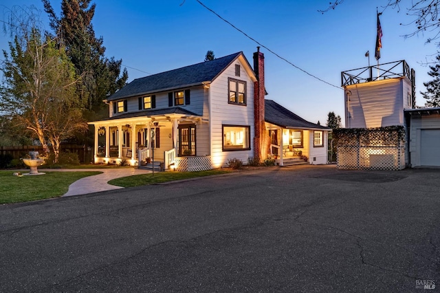 view of front of property with covered porch and a garage