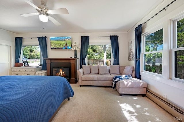 bedroom featuring light carpet, baseboard heating, ornamental molding, and ceiling fan