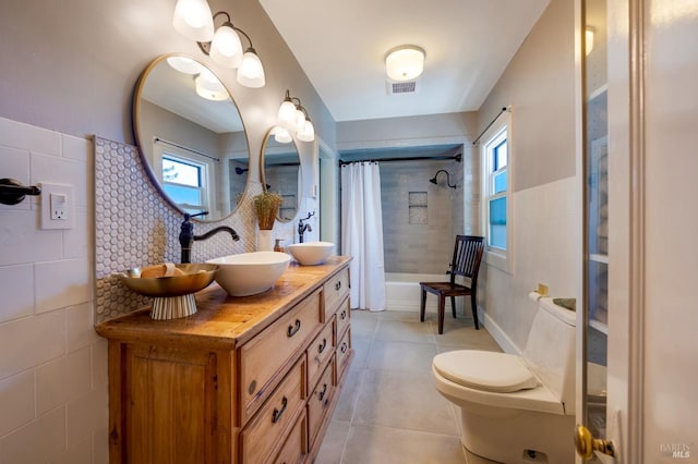 full bathroom with shower / bath combo with shower curtain, toilet, and vanity