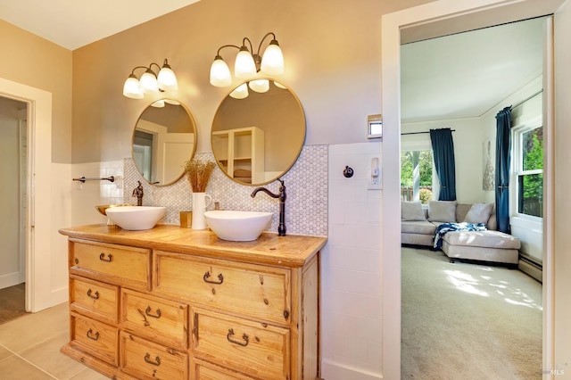 bathroom with vanity, backsplash, and a baseboard radiator