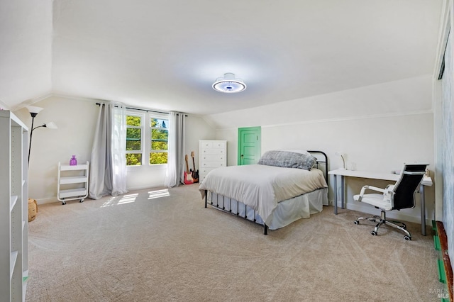 bedroom with lofted ceiling and light colored carpet