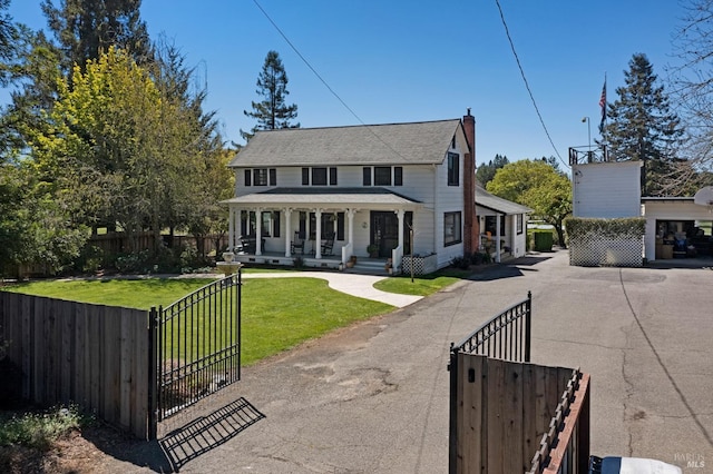 view of front of property with a front yard and covered porch