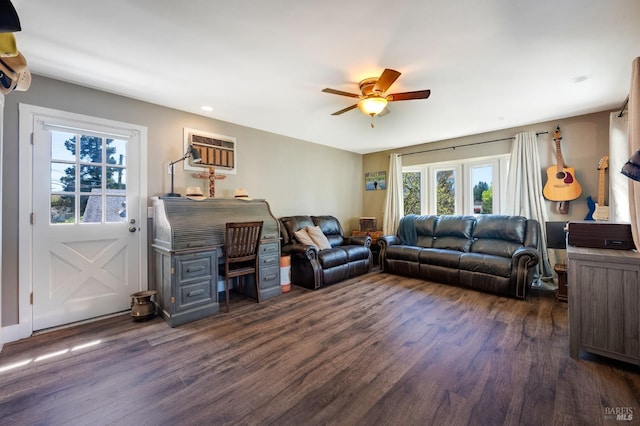 living room with ceiling fan, dark hardwood / wood-style flooring, and a wall mounted AC