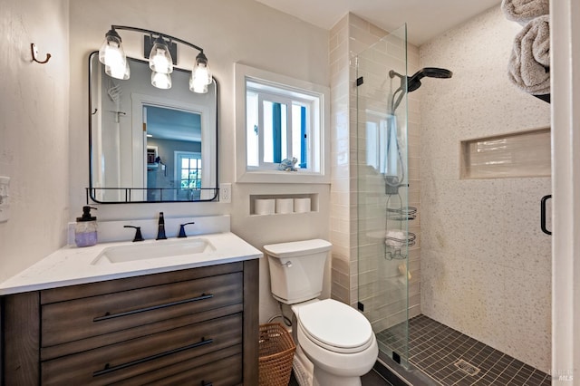 bathroom with walk in shower, vanity, and toilet