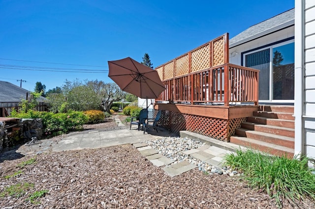 view of yard with a patio area and a wooden deck