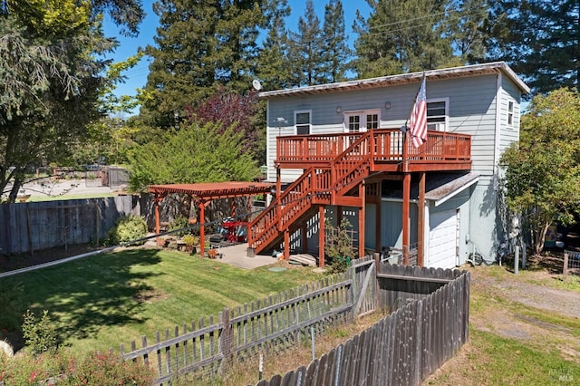 back of house featuring a deck and a yard