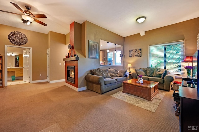 carpeted living room with ceiling fan