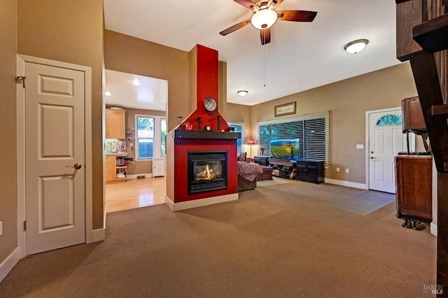 unfurnished living room featuring ceiling fan and carpet