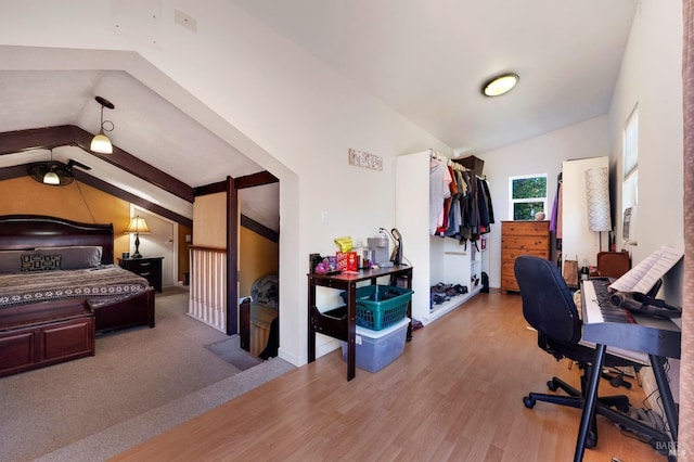 bedroom with hardwood / wood-style flooring and vaulted ceiling with beams