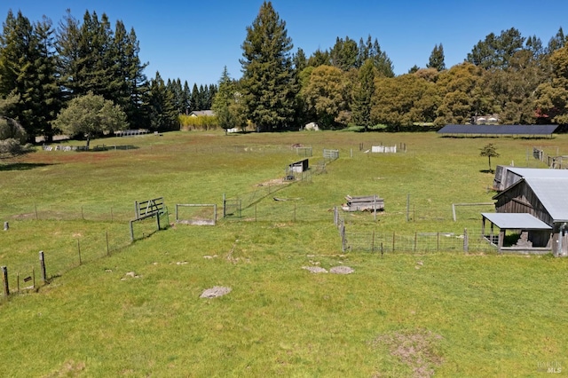 view of yard featuring a rural view and an outdoor structure