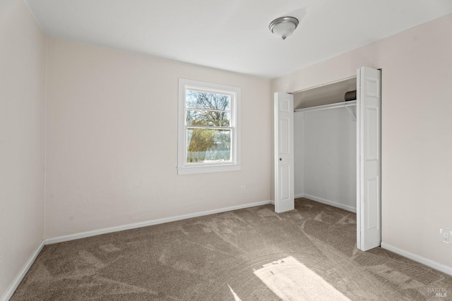 unfurnished bedroom with carpet floors and a closet