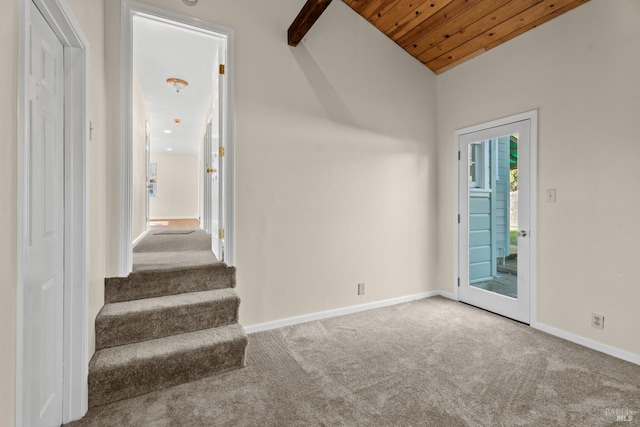 interior space featuring lofted ceiling, wooden ceiling, and carpet