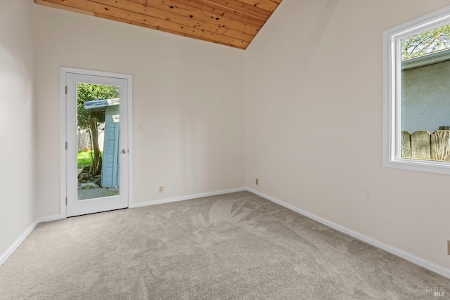 carpeted spare room with lofted ceiling and wood ceiling